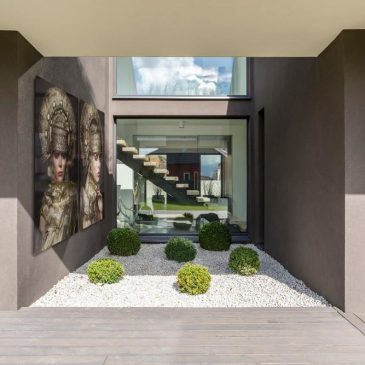 Exterior of modern gray villa with terrace and green plants