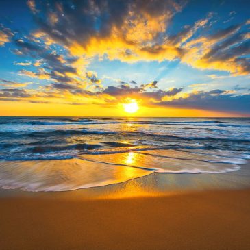 Beach photo with a radiant sunrise