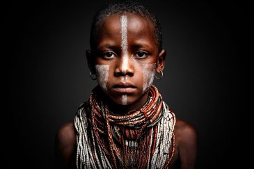 African Boy schilderij portret met Afrikaanse invloeden en traditionele sieraden warme tinten
